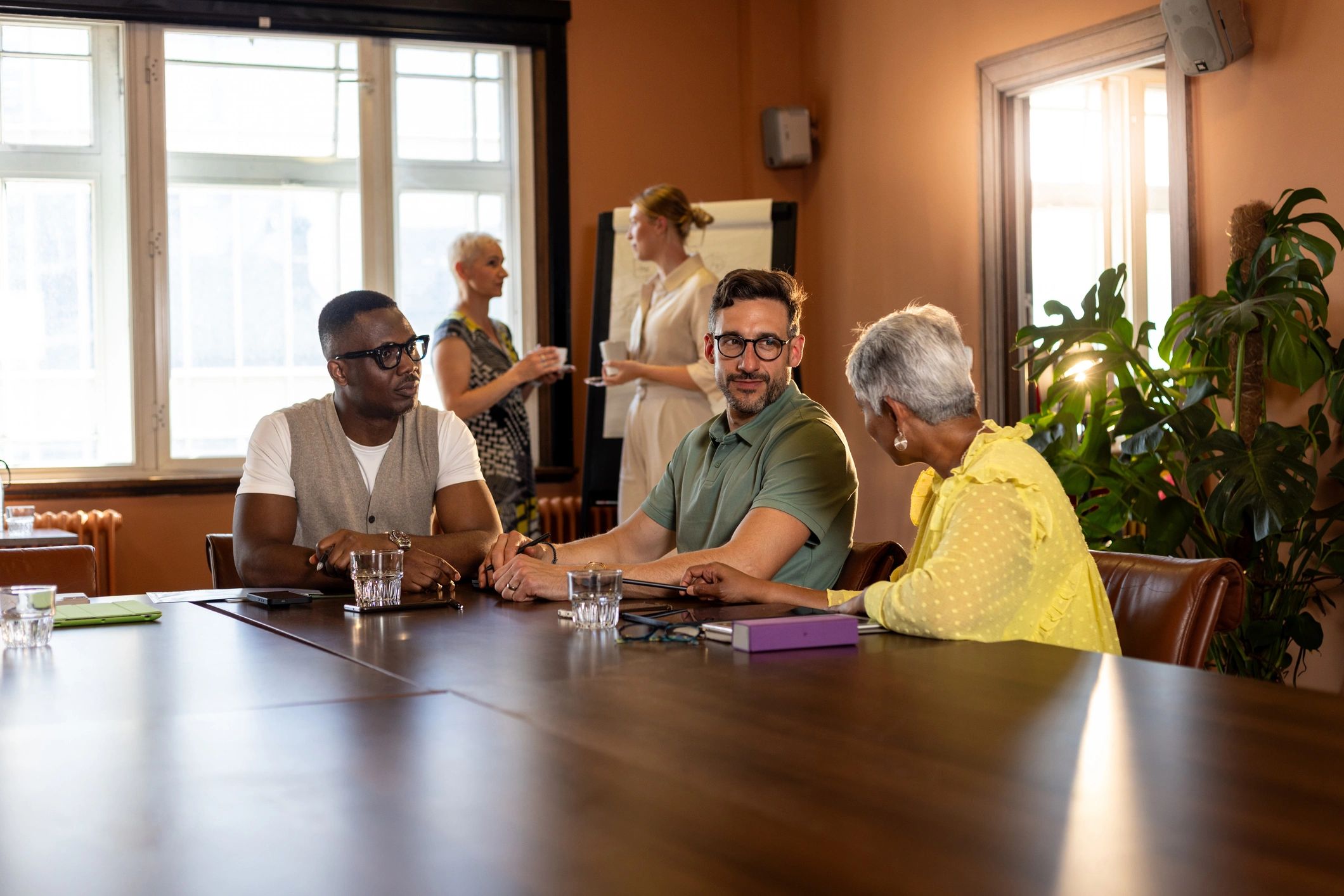Community association board members in discussion around a meeting table